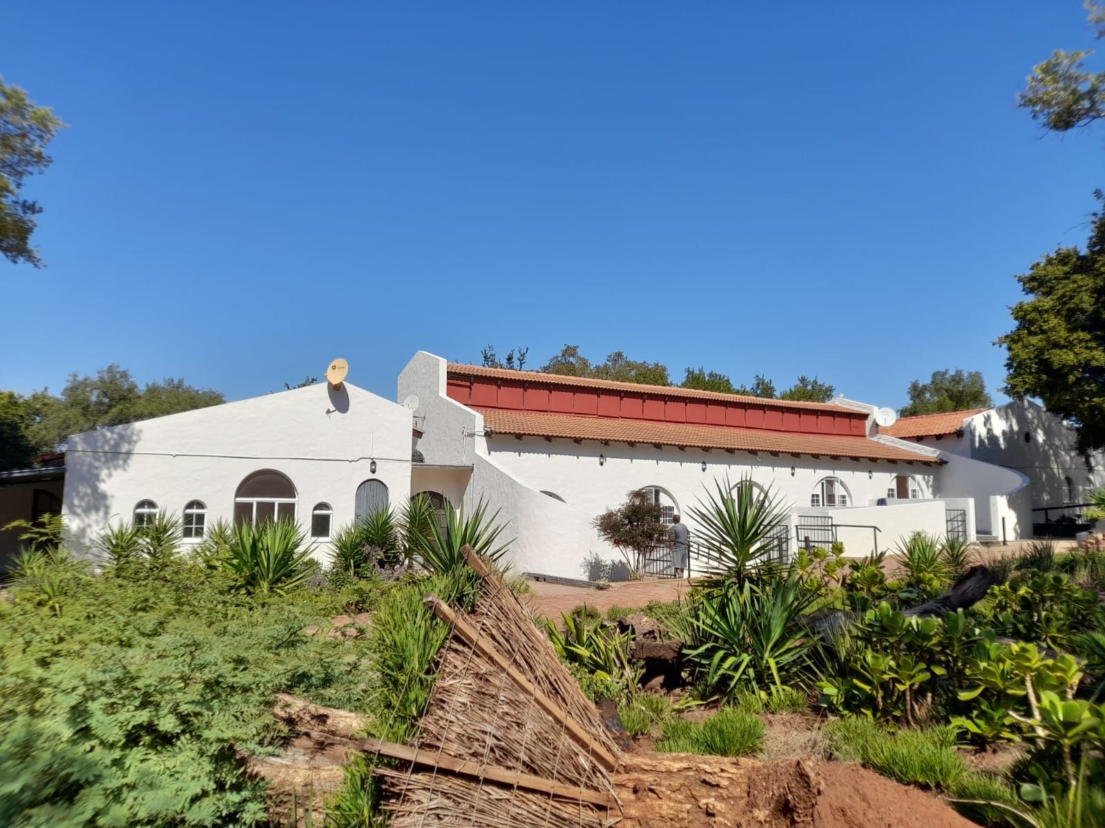 The whitewashed buildings and gardens of Aloe Valley Wellness Manor